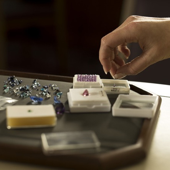 hand selecting gemstones