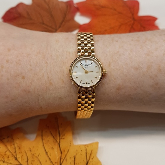 Tissot watch with autumn leaves