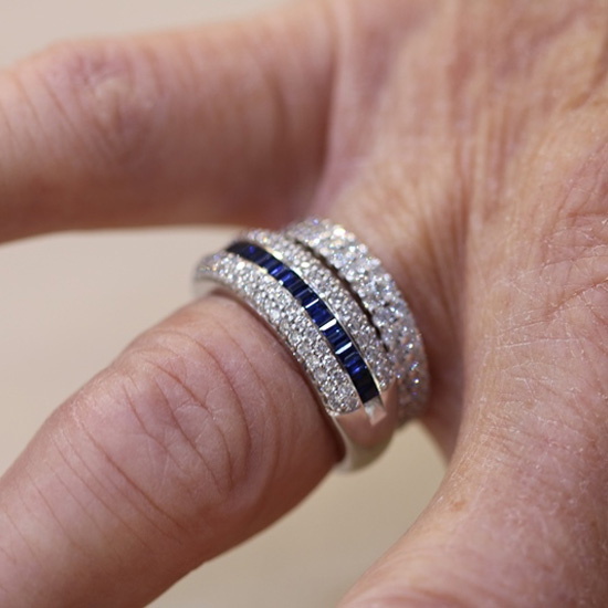 sapphire and diamond ring on customers hand